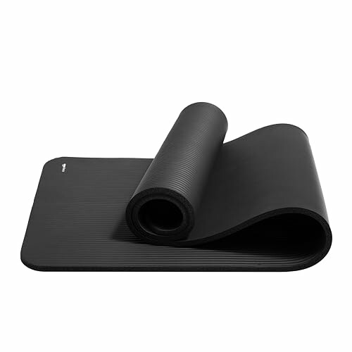 Black yoga mat partially rolled up