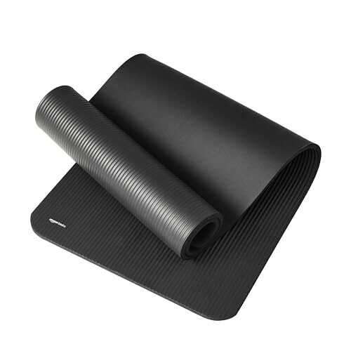 Black rolled yoga mat on white background