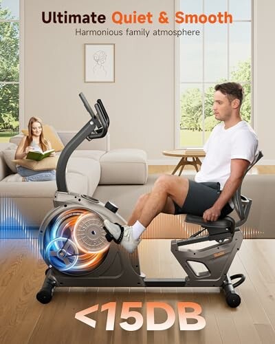 Man using a quiet exercise bike indoors with woman reading in background