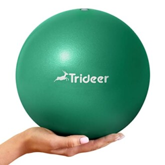 Green exercise ball held in a hand.