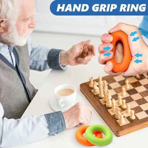 Elderly man using hand grip ring near chessboard and cup