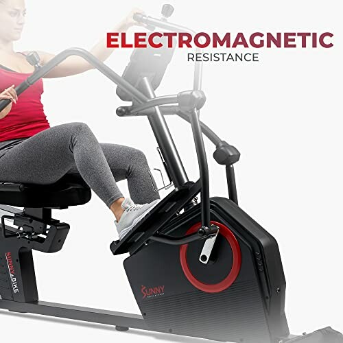 Person using a recumbent exercise bike with electromagnetic resistance.