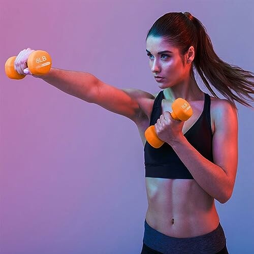 Woman exercising with orange dumbbells