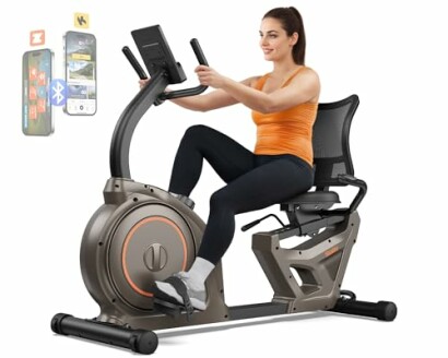 Woman using a recumbent exercise bike with a digital display.